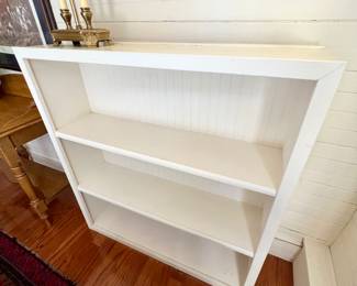 White bookcase with bead board backing