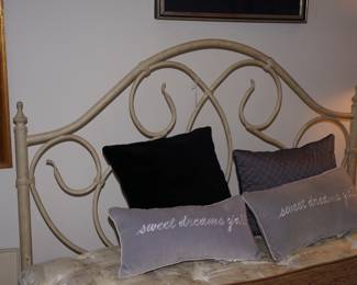 Queen size bed. The metal frame has a rustic cream colored finish