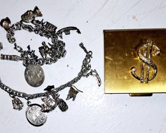 Table full costume jewelry. Souvenir charm bracelets, some sterling charms.