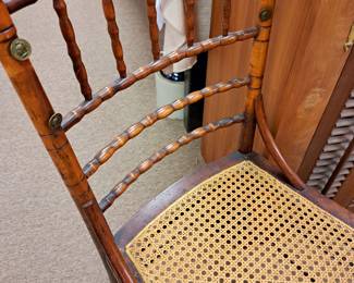 Victorian spindle back chair w/ cane bottom and cool brass tabs.