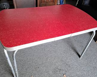 Tables. Retro red enamel top table with chrome legs and one leaf