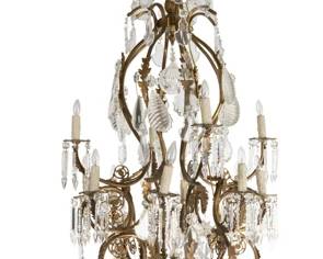 French style gilt bronze chandelier with high quality and cut heavy prisms and globes.  It is stunning in person and somewhat unusual in shape and size.  It measures 57" tall by 32" wide.
