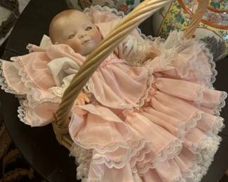 Very sweet antique doll in new clothing with working moving eyes and Porcelain head, feet, and arms.  It is signed on the back.