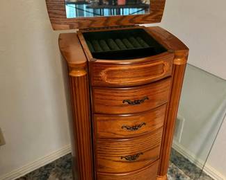 Standing wooden Jewelry Armoire with lots of storage and sides that open