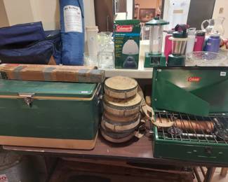 Coleman cooler and stove, metal stands, antique military grade canteens.