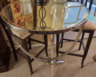Glass top bistro table with chrome base. Bar stools sol seperately.