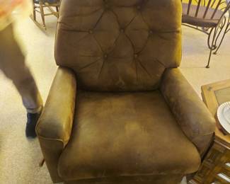 Upholstered rocker swivels and reclines.