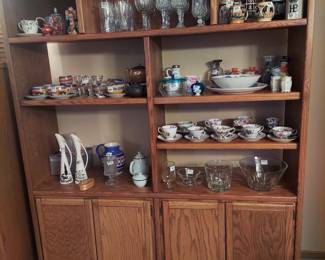 Large oak cabinets. Collectible glass and stone wares.