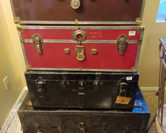 Assorted foot lockers and trunks.