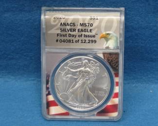 Lot 122. 2020 American Silver Eagle First day of issue containing 1 oz. pure silver graded by ANACS-MS70 in an attractive wooden display box.