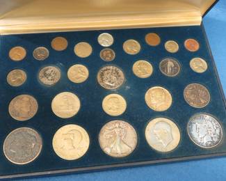 Lot 94. 27 coins in a display box entitled Coins of the Twentieth Century. Included are many silver coins.