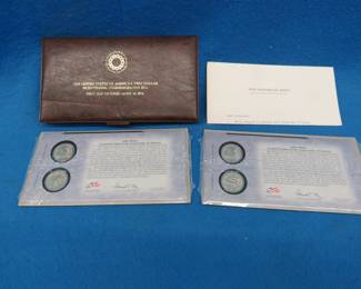 Lot 65. Two packets of two each gold-colored John Adams dollar coins (four coins total). $2 Bicentennial Commemorative Bill-First day of issue-April 13 1976.