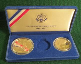 Lot 44. 1986 US Mint Liberty Silver Dollar and non-silver Half Dollar (there is no Gold $5 Coin) in an attractive display box. The silver dollar has .77 troy oz of .900 silver.