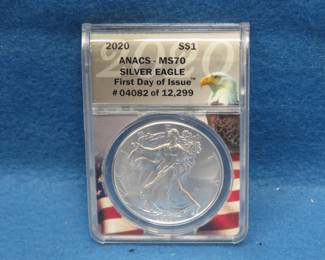 Lot 123. 2020 American Silver Eagle First day of issue containing 1 oz. pure silver graded by ANACS-MS70 in an attractive wooden display box.