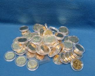 Lot 135. 58 Encapsulated Gold-Colored, High-Grade State Quarters