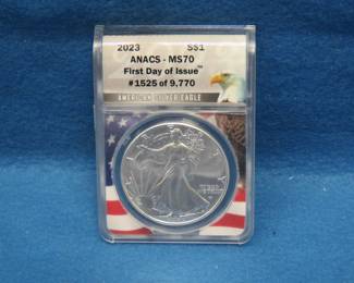 Lot 121. 2023 American Silver Eagle First day of issue containing 1 oz. pure silver graded by ANACS-MS70 in an attractive wooden display box.