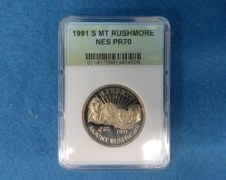 Lot 132. 1991 Gold-Colored Mount Rushmore Golden Anniversary Half Dollar. Two 1972 Gold-Colored Eisenhower Dollars.
