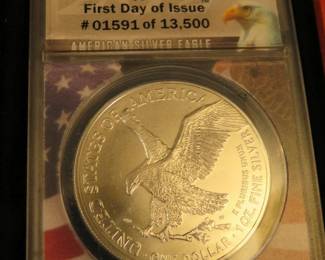 Lot 17. 2021 American Silver Eagle First day of issue containing 1 oz. pure silver graded by ANACS-MS70 Type II in an attractive wooden display box.