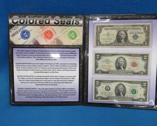 Lot 178. Folder from the First Commemorative Mint entitled Colored Seals: 1 blue seal $1 Silver Certificate, one red seal $2 bill, and one green seal $2 bill.
