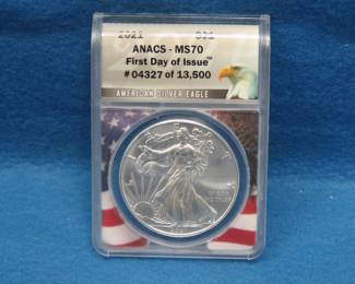Lot 120. 2021 American Silver Eagle First day of issue containing 1 oz. pure silver graded by ANACS-MS70 in an attractive wooden display box.
