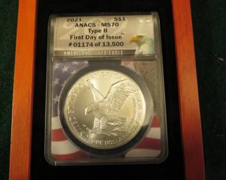 Lot 12. 2021 American Silver Eagle First day of issue containing 1 oz. pure silver graded by ANACS-MS70 Type II in an attractive wooden display box.