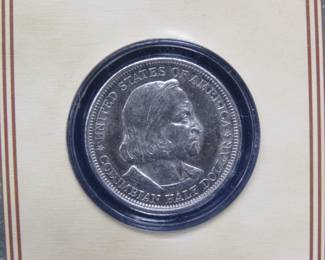 Lot 207. 1893 Columbian Exposition Half Dollar in a display case with description