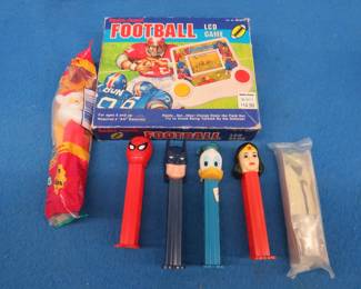 Lot 239. Pez dispensers and a 1993 Radio Shack LCD football game