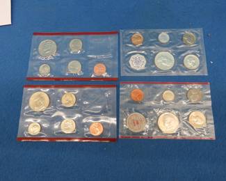 Lot 185. One 1960 P US Mint uncirculated coin set. One 1964 D US Mint uncirculated coin set. Two 2004 D US Mint uncirculated coin sets WITHOUT the quarters.