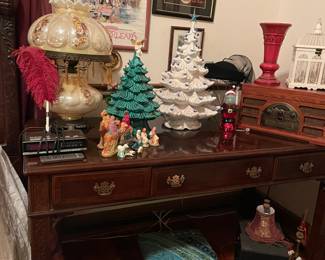 Desk, lamps, two ceramic Christmas Trees.   The white one has blue bird bulbs, Crosley  stereo Player