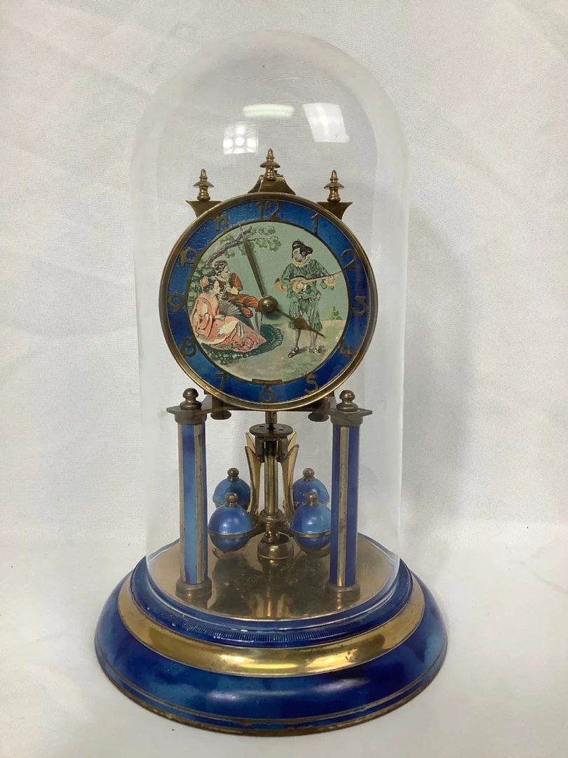 REEM810 Vintage Torsion Pendulum Anniversary Clock Vintage torsion pendulum clock, also known as an anniversary clock or 400 day clock, from Jahresuhrenfabrik, or the Schatz Clock Company. Stamped as made in 1949. Not operational from the key, which will not actually turn despite being included, but if set spinning manually, otherwise keeps time as normal.
