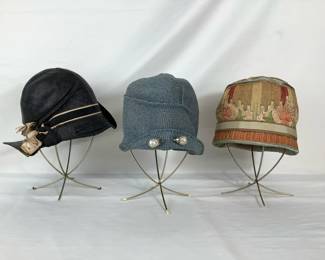 BIHY204 1920s1930s Cloche Hat Trio Black with a black and tan ribbon with a flower design on the side of the hat.
