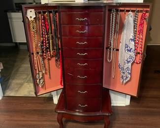 Queen Anne style jewelry chest with eight drawers and two side panels that swing out for hanging longer necklaces.