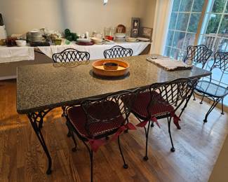 Granite dining table on wrought iron base with chairs, $140.00