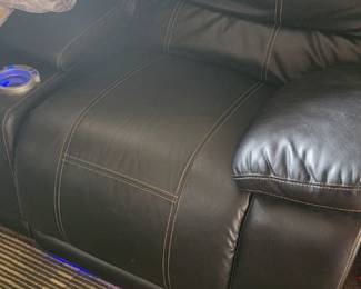 Two seater leather couch. Both seats recline. Middle console and cup holder and cell charger.