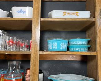 The 1 1/2 qt. casserole dish on the top shelf is the wheat pattern by Anchor Hocking. To the left of the wheat pattern is the 1 3/4 qt. cornflower pattern by Pyrex. The blue1950's vintage Pyrex in this picture is amazing. The Amish butter print pattern features a butter dish and a set of 4 mixing bowls. On the shelf above are 3 casserole dishes.