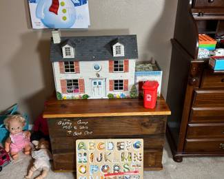 Be sure to notice the vintage doll house sitting on the toy box.