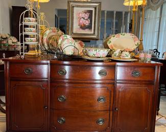 The antique mahogany buffet has 5 drawers and 2 cabinets. It measures 48w x 19d x 32h. Sitting on the buffet is Desert Rose china by Franciscan. There are 90 pieces of this china in this sale.