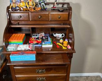 This roll top desk would be the perfect size for a child. The built in storage and the pullout writing surface make it so convenient for homework and reading time.