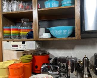 Sitting on the counter are several pieces of vintage Tupperware in excellent condition.