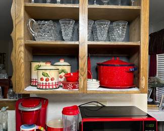 The middle shelf is displaying the mid century footed tumblers and pitcher by White Hall.