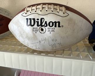 We have two footballs and one baseball filled with autographs. Do you know what team they’re from?