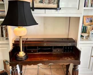 Vintage campaign-style desk and vintage brass and glass lamp