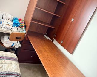 Murphy-style desk - one side of the L-shaped desk can be raised and stowed in tall cabinet. This photo shows the desk lowered.