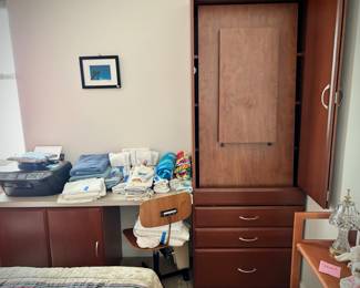 Murphy-style desk - one side of the L-shaped desk can be raised and stowed in tall cabinet. This photo shows the desk raised. 