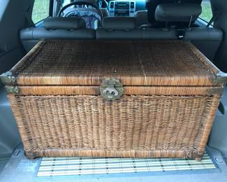 large wicker and brass trunk