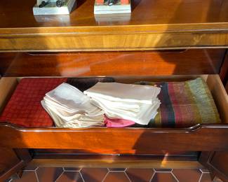 Linens In breakfront drawers.