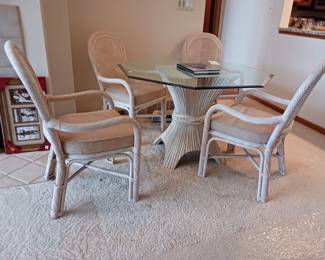 Glass dining table with four wicker chairs pedestal glass top