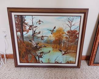Artist painting on canvas of mallard ducks landing on a pond