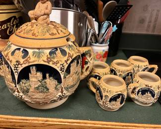 German bowl, lid and has place for ladle and has matching cups. 