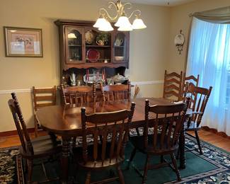 Nice solid wood dining table 6 chairs with Captain's chair.  Nice matching china cabinet.